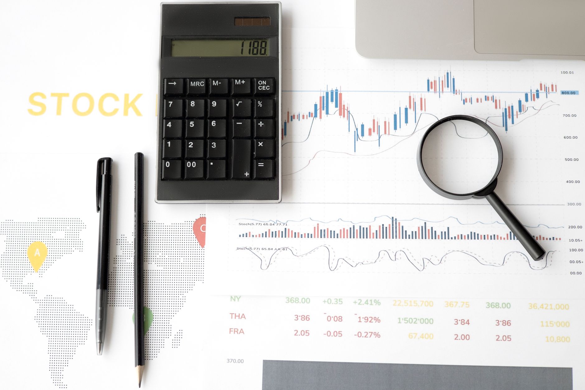 Calculator and survey sheets representing Dholera investment analysis