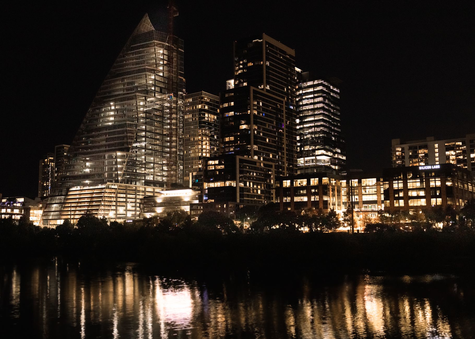 City skyline at night, representative of a premium smart-city district